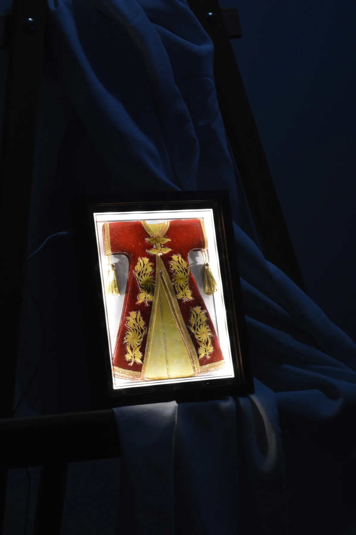 Illuminated red and gold paper relief tableau