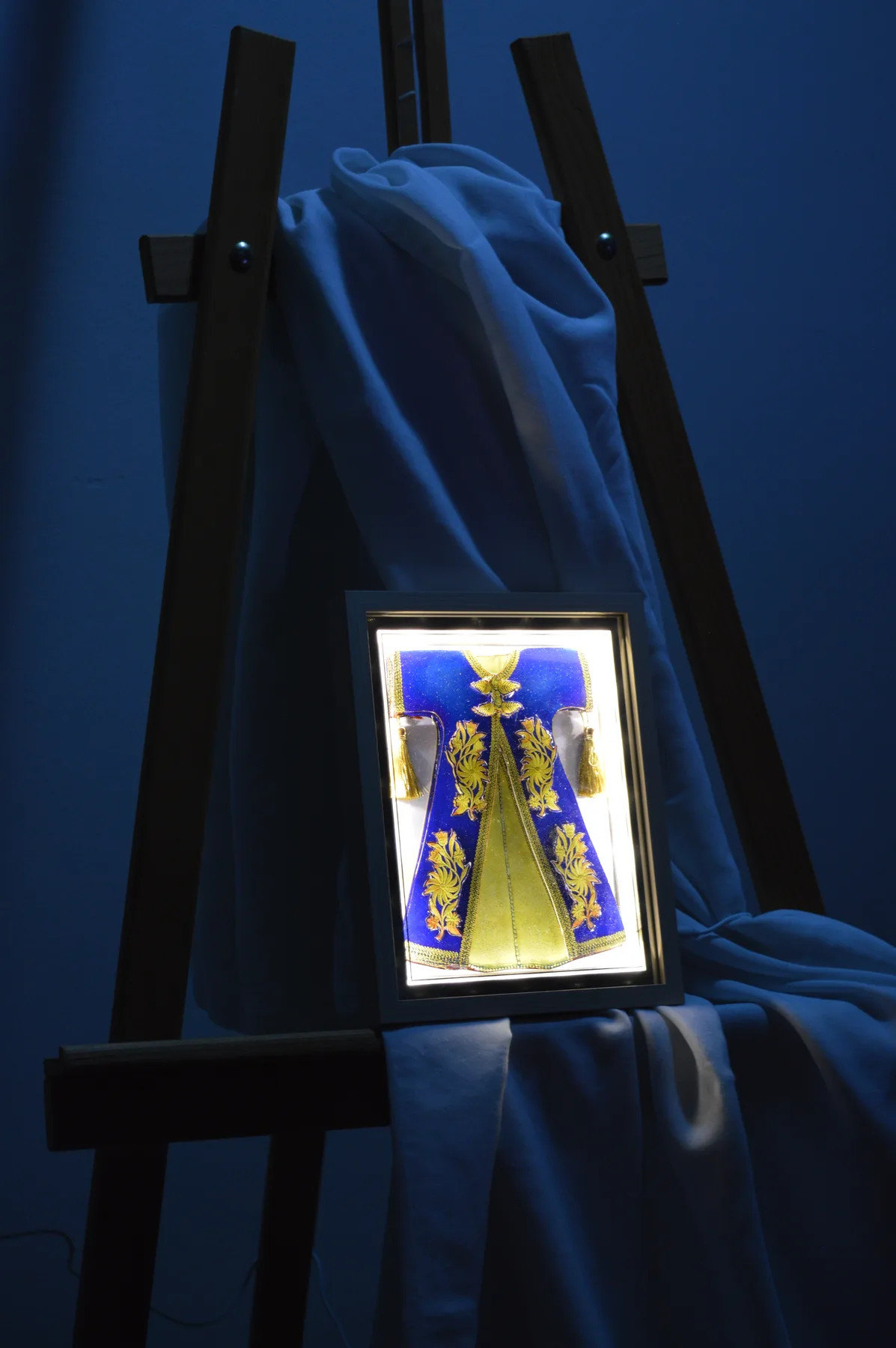 Blue illuminated paper relief artwork