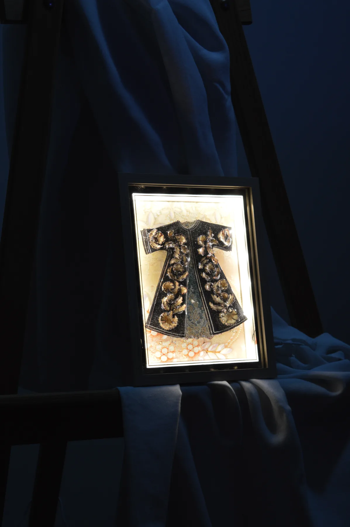Framed illuminated paper relief tableau